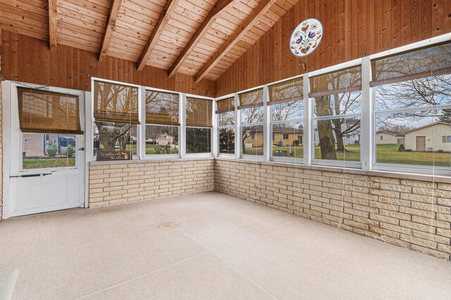 unfurnished sunroom with lofted ceiling with beams and wood ceiling