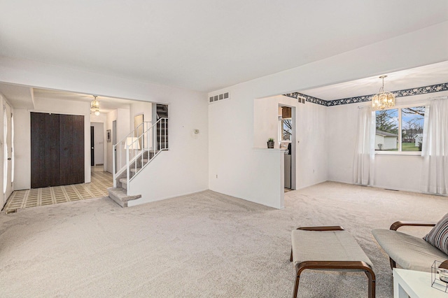 unfurnished living room featuring light carpet and a notable chandelier