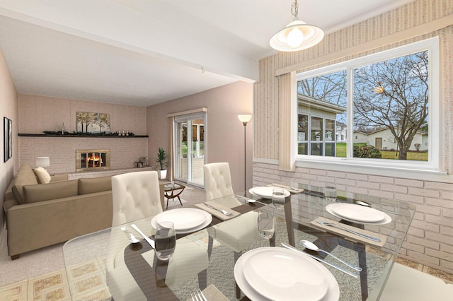 dining area with a brick fireplace