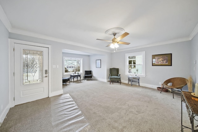 interior space featuring carpet, plenty of natural light, ceiling fan, and crown molding