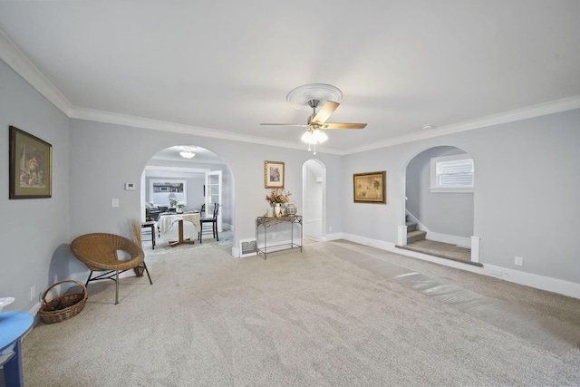 unfurnished room featuring light colored carpet, ceiling fan, and crown molding