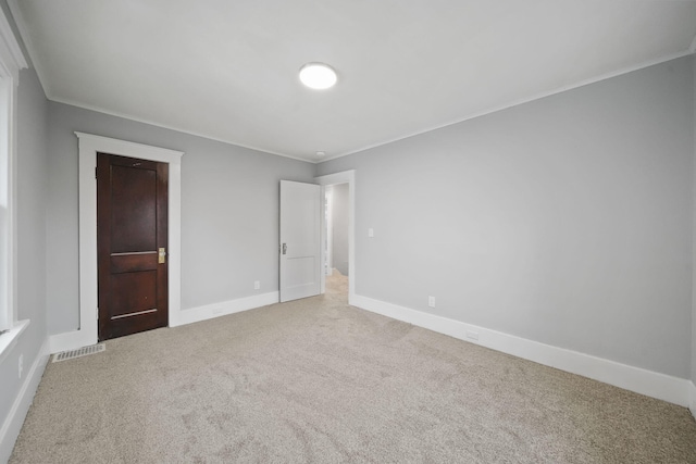 unfurnished bedroom with carpet and ornamental molding