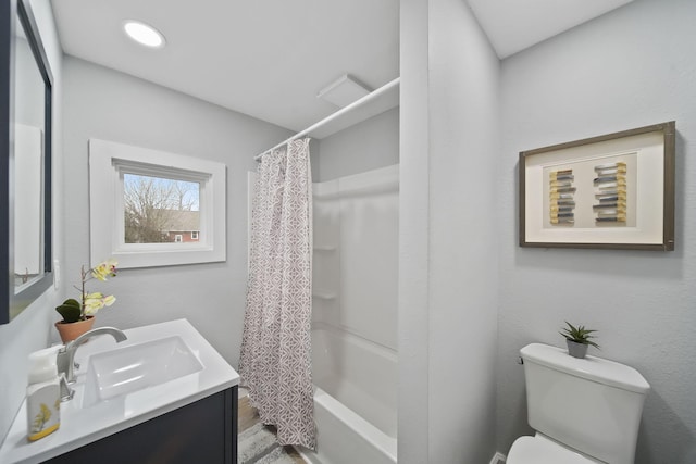 full bathroom with hardwood / wood-style flooring, vanity, toilet, and shower / tub combo