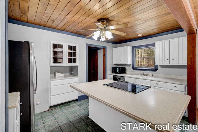 kitchen with black appliances, white cabinetry, and wooden ceiling