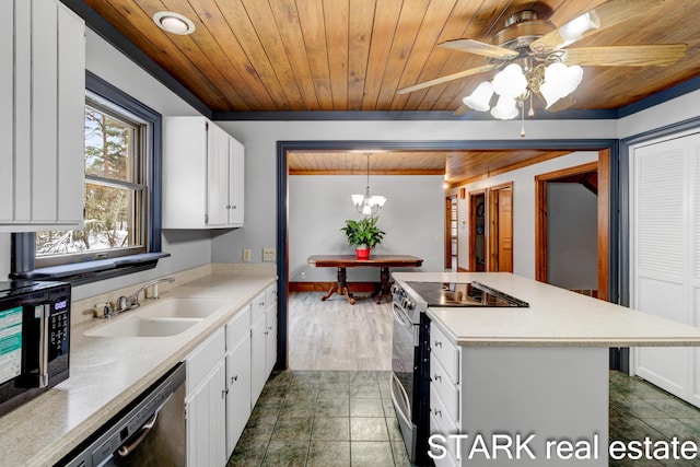 kitchen featuring white cabinets, hanging light fixtures, sink, appliances with stainless steel finishes, and wood ceiling