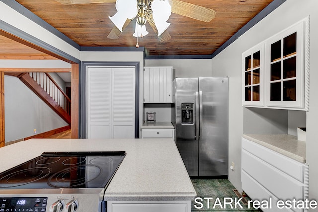 kitchen with white cabinets, stainless steel fridge, stove, and wood ceiling