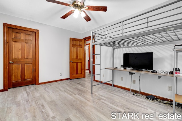 unfurnished bedroom with ceiling fan and light hardwood / wood-style flooring