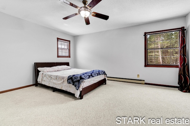 bedroom with carpet flooring, a textured ceiling, a baseboard radiator, and ceiling fan