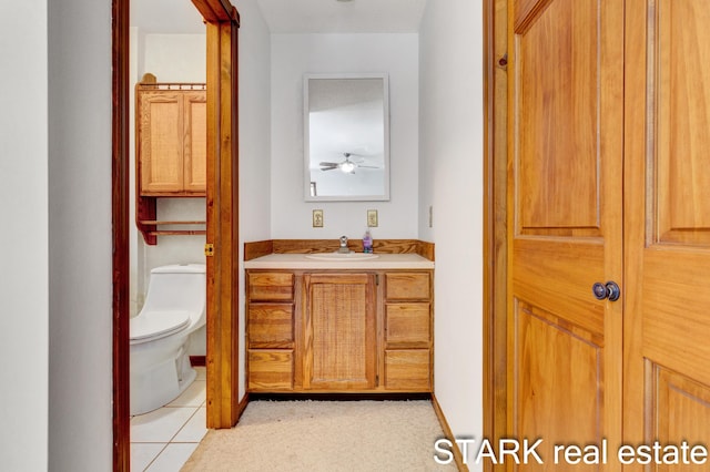 bathroom featuring tile patterned flooring, vanity, toilet, and ceiling fan