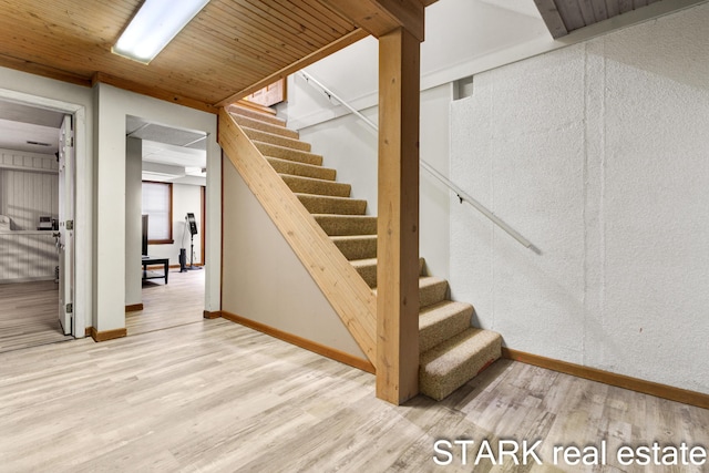 stairway with hardwood / wood-style flooring and wood ceiling