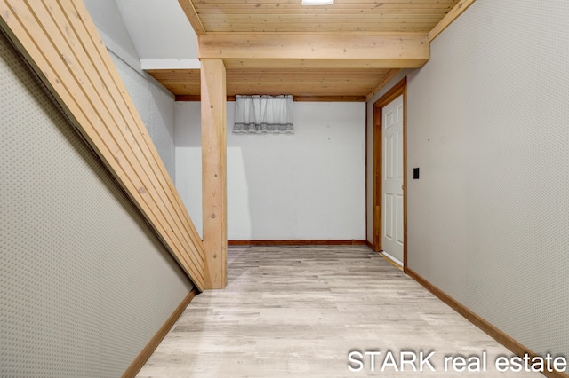 corridor with wooden ceiling and light hardwood / wood-style flooring