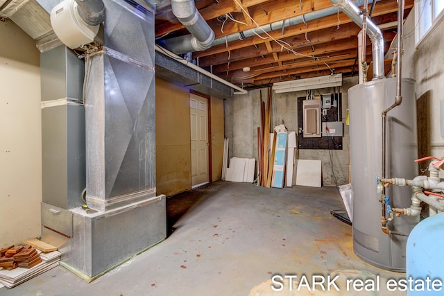 basement featuring electric panel, water heater, and heating unit