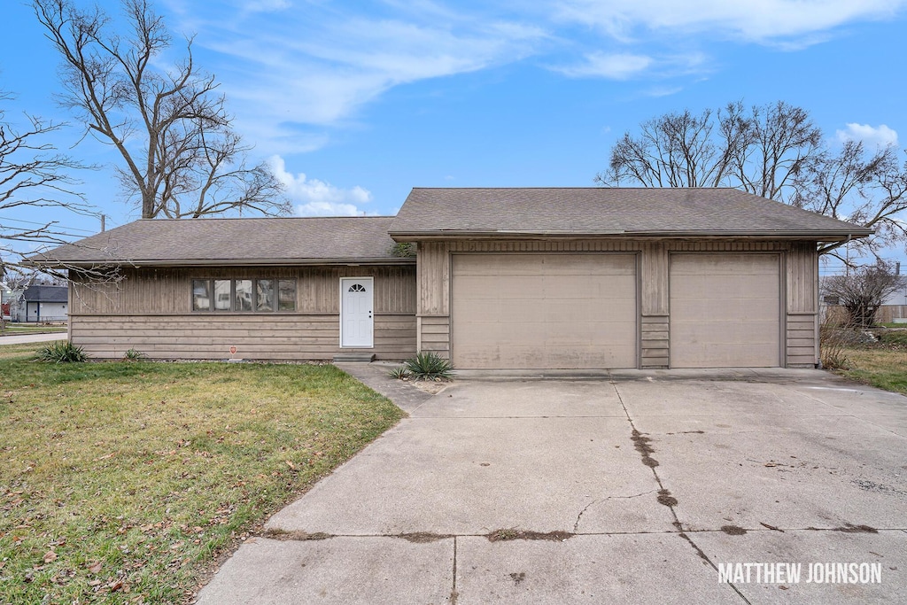 single story home with a garage and a front yard