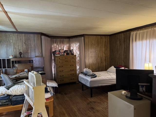 bedroom with dark wood-type flooring and wooden walls