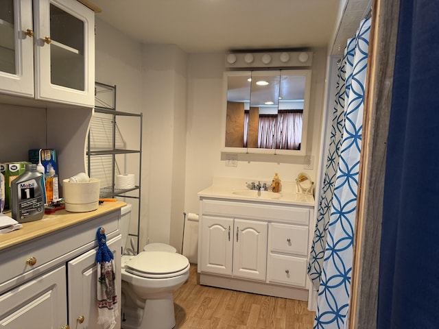 bathroom featuring hardwood / wood-style floors, vanity, and toilet