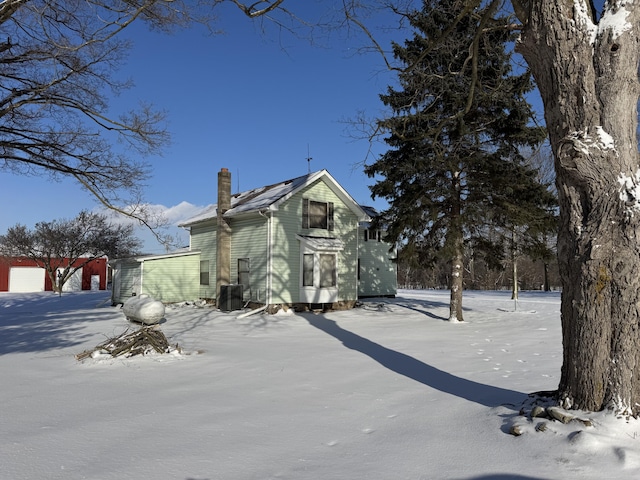 view of snow covered exterior featuring cooling unit