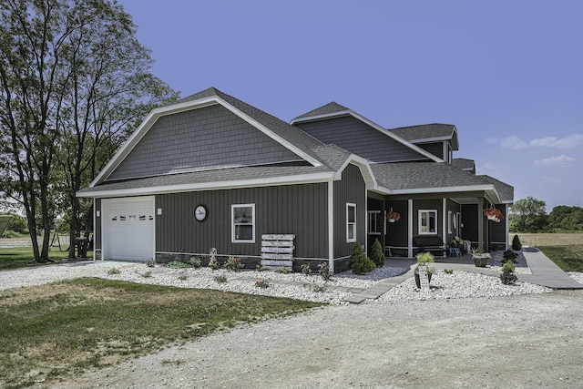 view of front facade featuring covered porch and a garage