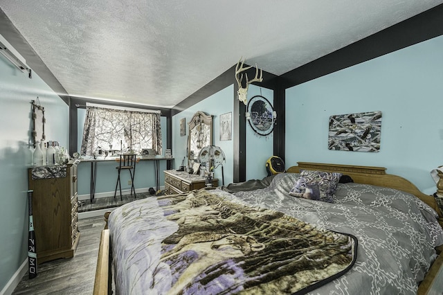 bedroom featuring hardwood / wood-style floors and a textured ceiling