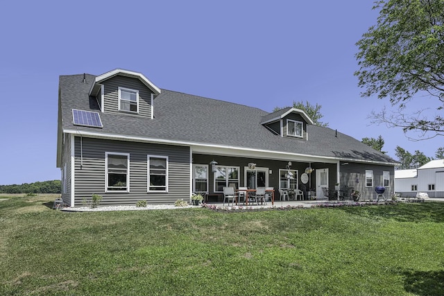 rear view of house featuring a yard and a patio