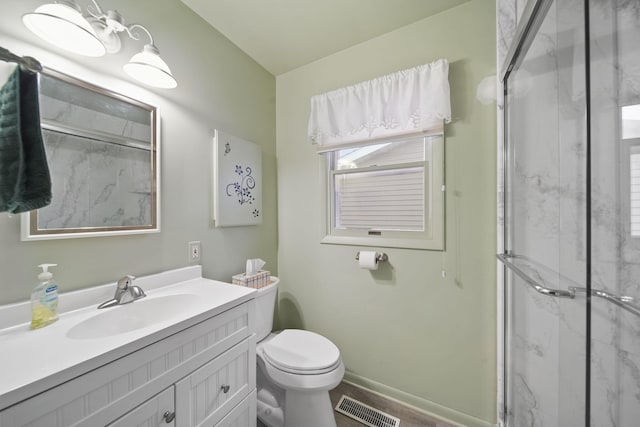 bathroom with vanity, an enclosed shower, and toilet