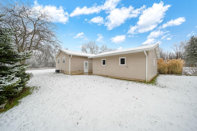 snow covered house with cooling unit