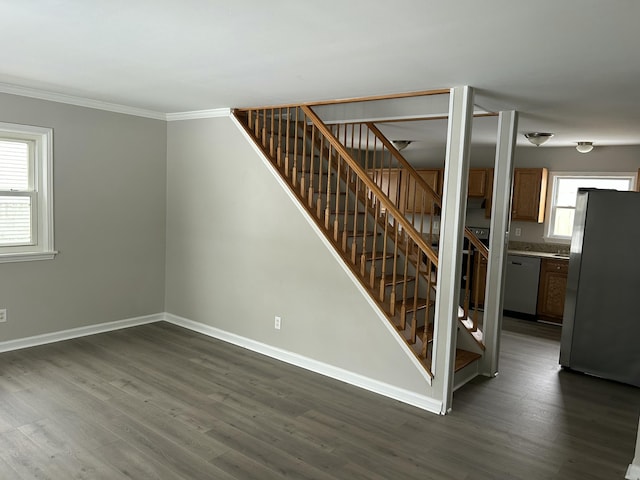 staircase with hardwood / wood-style floors and ornamental molding