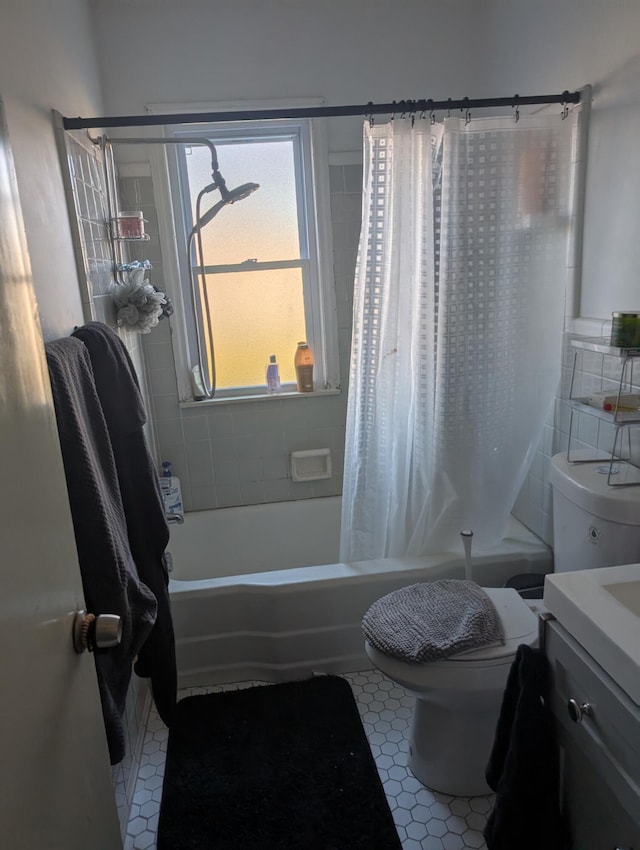 full bathroom featuring tile patterned flooring, vanity, toilet, and shower / bath combo with shower curtain