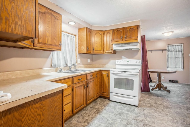 kitchen featuring electric range, sink, and a textured ceiling