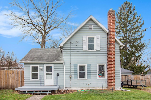 rear view of property with a deck and a lawn