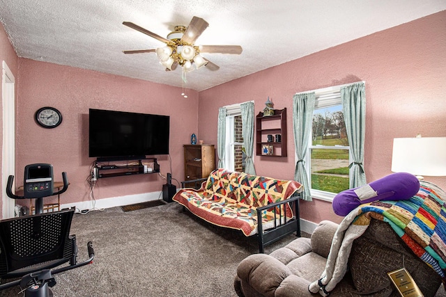 carpeted living room with ceiling fan and a textured ceiling