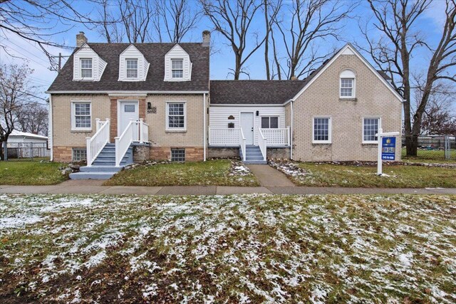 cape cod home with a yard