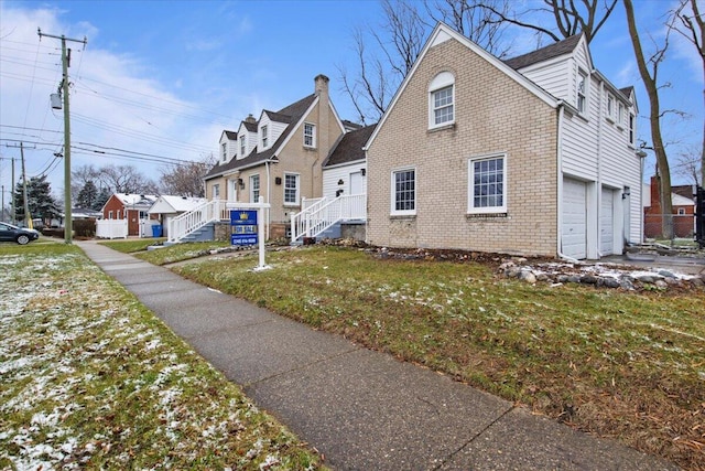 view of side of home featuring a lawn and a garage