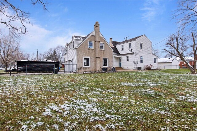 rear view of property with a yard