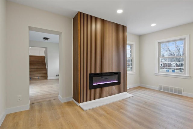 unfurnished living room featuring light hardwood / wood-style floors