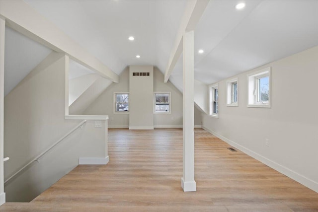 additional living space with lofted ceiling and light wood-type flooring