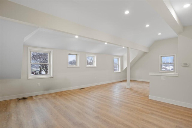 bonus room featuring a healthy amount of sunlight, vaulted ceiling, and light hardwood / wood-style floors