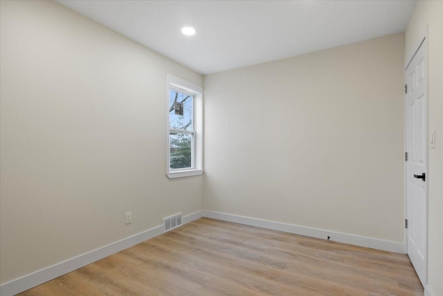 unfurnished room with light wood-type flooring