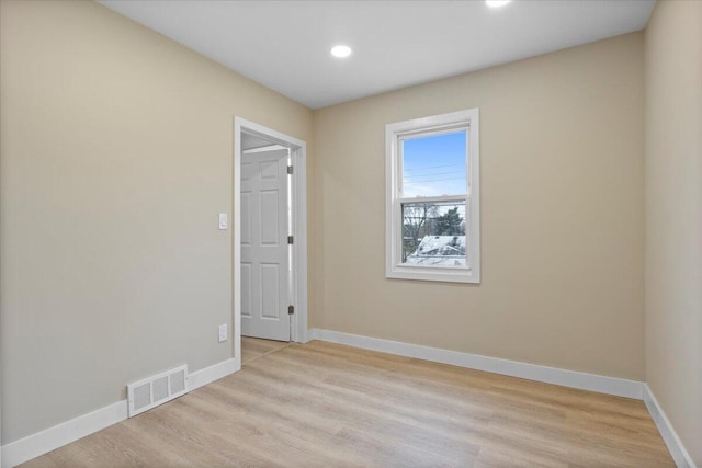 spare room featuring light wood-type flooring