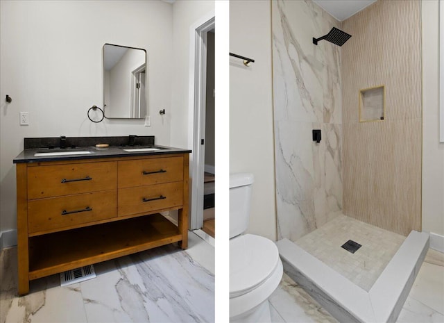 bathroom featuring a tile shower, vanity, and toilet