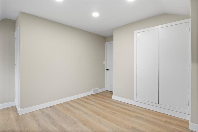 unfurnished bedroom with light hardwood / wood-style floors and a closet