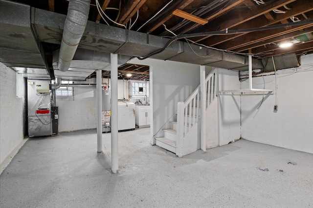 basement with washing machine and dryer, water heater, and heating unit