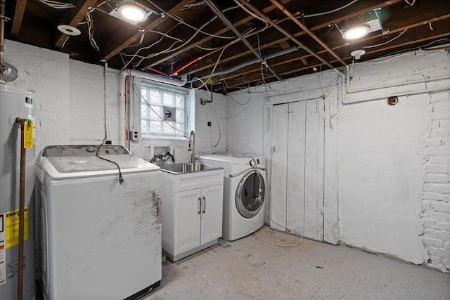 laundry area featuring washer and dryer, electric water heater, cabinets, and sink