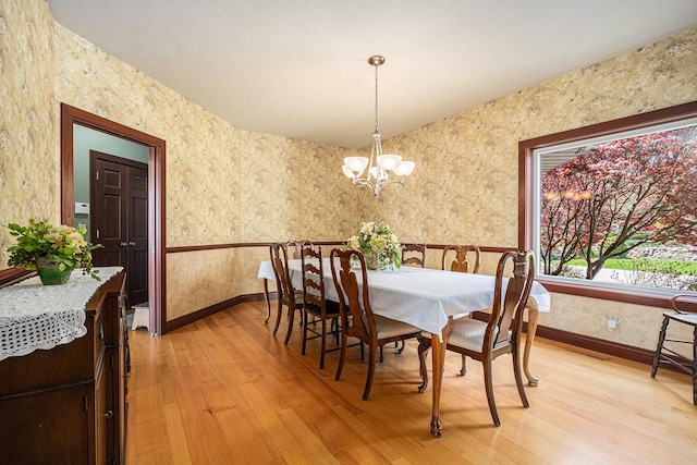 dining space with a notable chandelier and hardwood / wood-style flooring