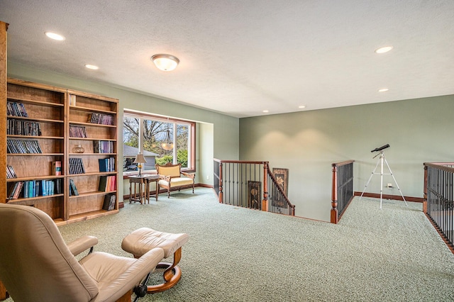 living area with carpet flooring and a textured ceiling