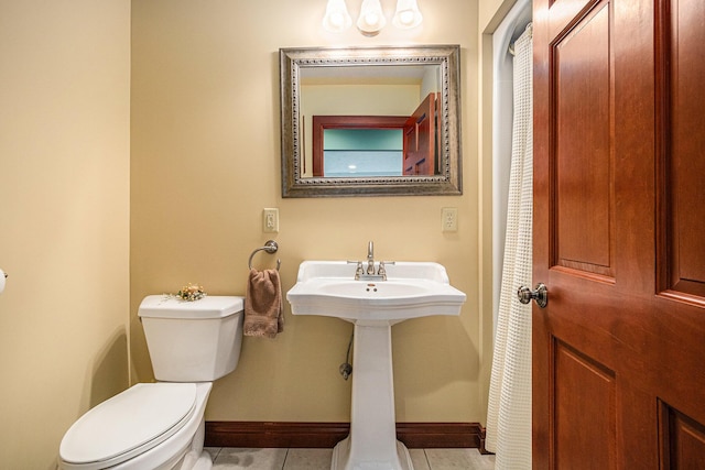 bathroom with tile patterned floors and toilet