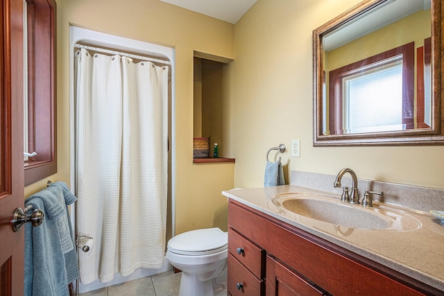 bathroom featuring tile patterned floors, vanity, toilet, and walk in shower