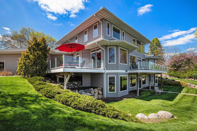 rear view of property with a lawn