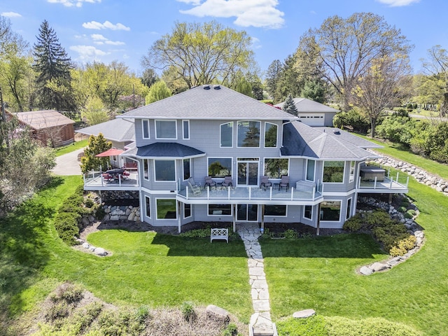 back of property with a deck and a yard