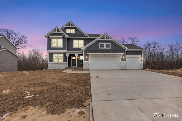 craftsman-style home with driveway and an attached garage