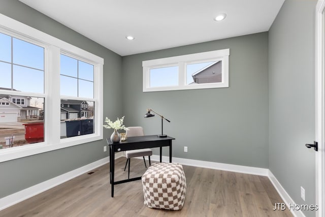 home office featuring baseboards and wood finished floors